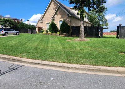 1333x616.jpeg.3be73ba9c26a4439a8a172d1d49e4730 Well-maintained lawn with striped grass, landscaped flower beds, and a residential home in Central Arkansas, showcasing APEX Lawn Care's professional lawn care services.