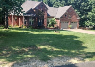 Beautiful brick home in LR with a perfectly mowed yard. - Little Rock Lawn Care and Mowing Services by Apex Lawn Care APEX Lawn Care service showcasing a well-maintained residential lawn in Little Rock, Arkansas, featuring a brick home and manicured grass area.