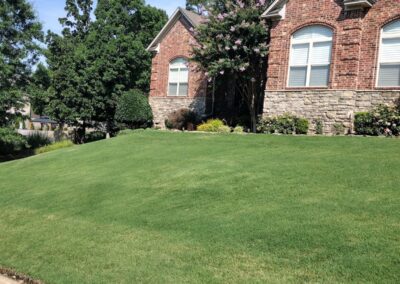 Another beautiful mow in Chenal Valley Little Rock by Apex Lawn Care Lush green lawn and well-maintained landscaping in front of a brick home, showcasing APEX Lawn Care services in Little Rock, Arkansas.