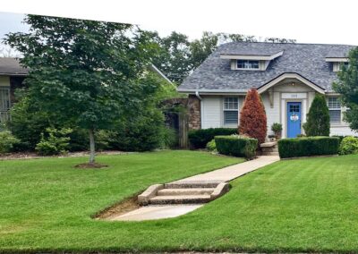 A quaint Little Rock Metro Area house with a well-manicured lawn and a stone pathway leading to the employee's front door. - Little Rock Lawn Care and Mowing Services by Apex Lawn Care A quaint Little Rock Metro Area house with a well-manicured lawn and a stone pathway leading to the employee's front door. - Little Rock Lawn Care and Mowing Services by Apex Lawn Care