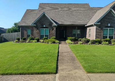 large-25 Well-maintained lawn in front of a brick home showcasing professional lawn care by APEX Lawn Care in Little Rock, Arkansas.