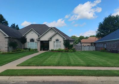 large-28 Lawn care service example showcasing a well-maintained lawn and landscaped home exterior in Central Arkansas.